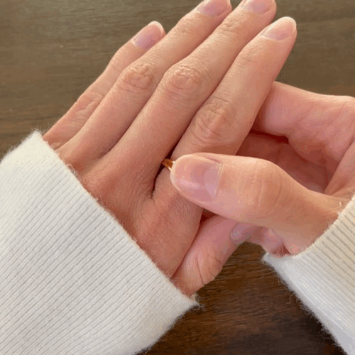 Animated spinning gold Allure three pearl fidget ring for anxiety relief, showcasing its movement