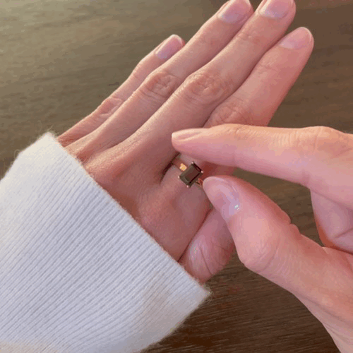 Animated spinning deep red charmed garnet fidget ring for anxiety relief, showcasing its movement