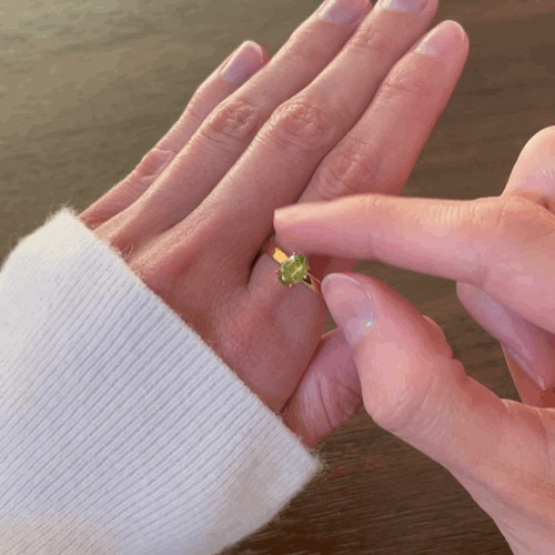 Animated spinning green Enlight peridot fidget ring for anxiety relief, showcasing its movement
