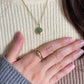 Close-up of the Grace green aventurine fidget necklace in gold with a dainty and calming design