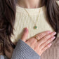 A Grace green aventurine dainty fidget necklace in gold worn with the pearl fidget ring