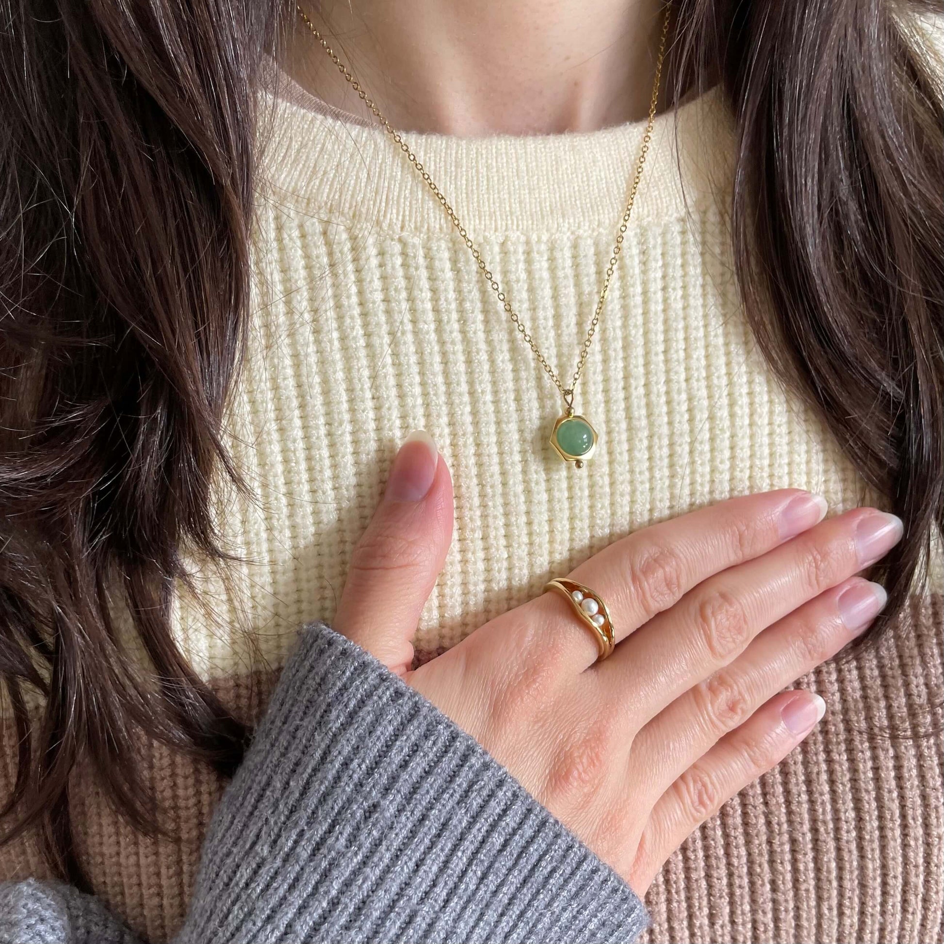 A Grace green aventurine dainty fidget necklace in gold worn with the pearl fidget ring