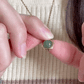 Animated spinning Grace green aventurine fidget necklace, showcasing its movement for anxiety relief