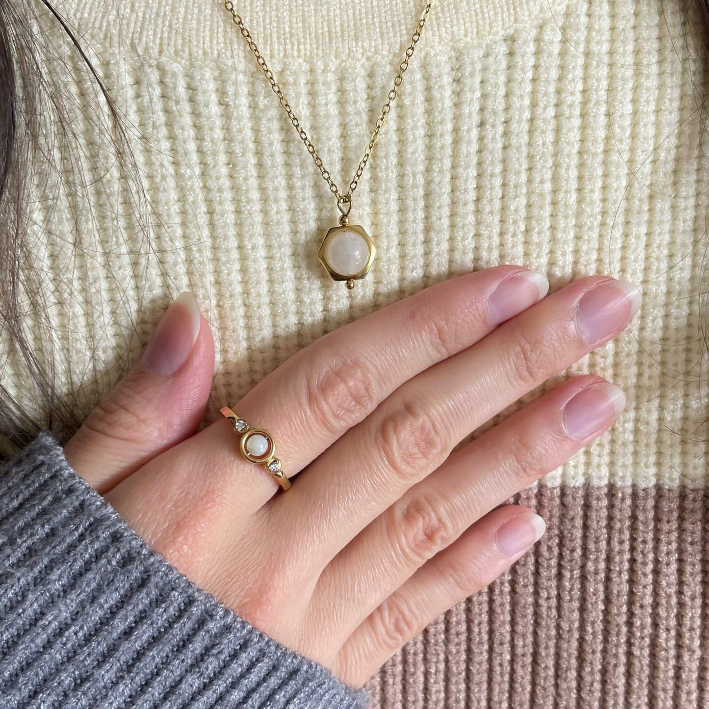 Close-up of the Luna moonstone fidget necklace in gold with a dainty and calming design