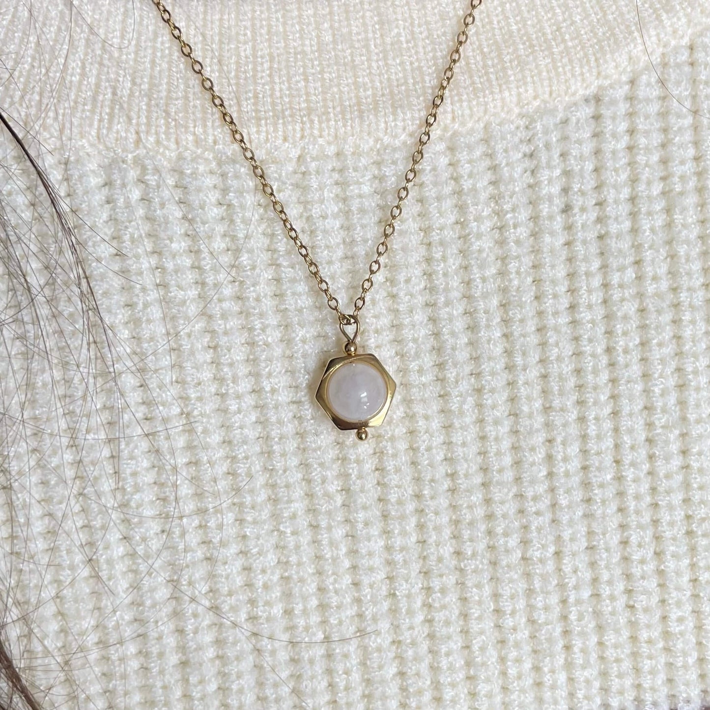 Close-up of the dainty Luna moonstone fidget necklace in gold