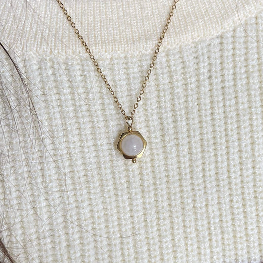 Close-up of the dainty Luna moonstone fidget necklace in gold