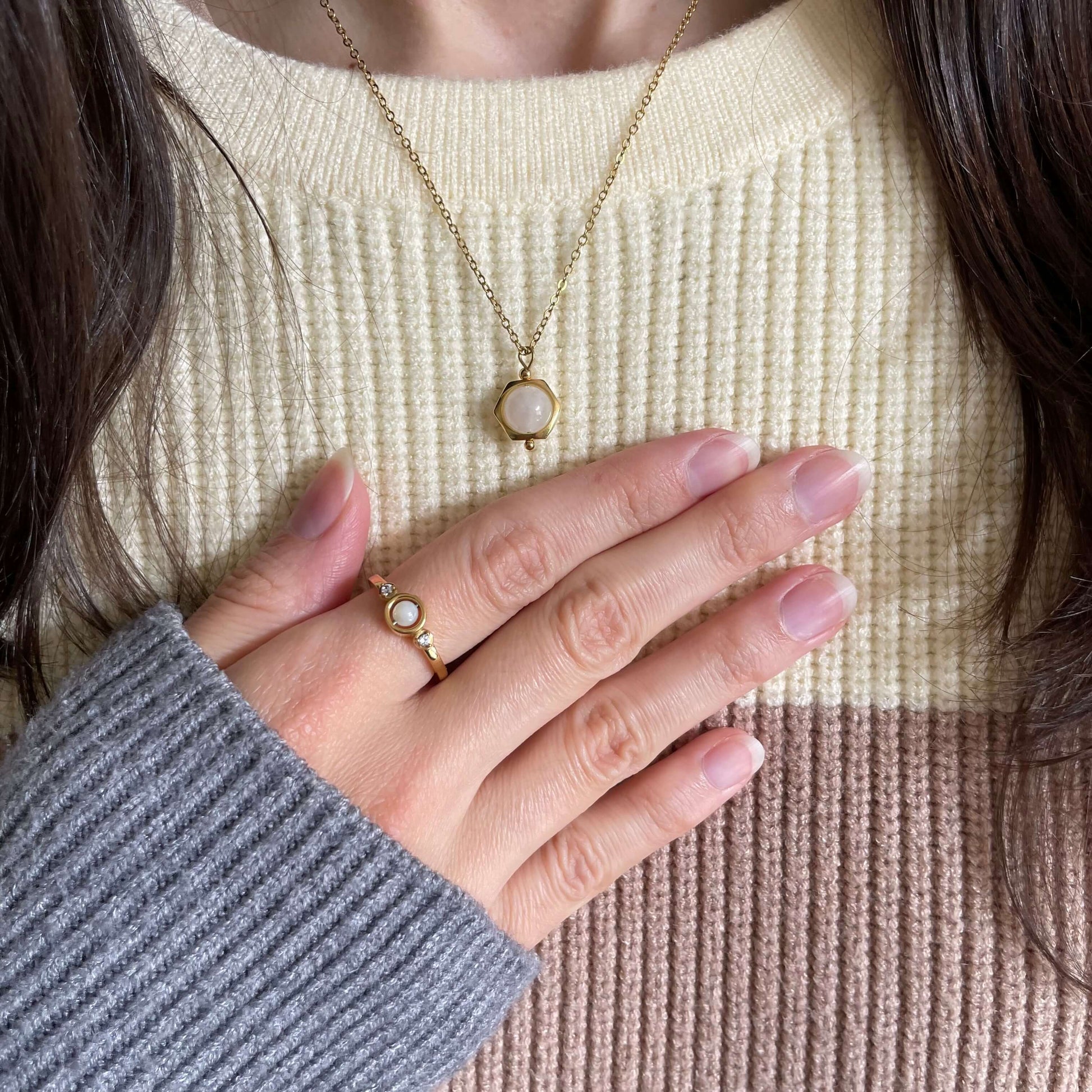 A Luna moonstone dainty fidget necklace in gold worn with the pearl fidget ring