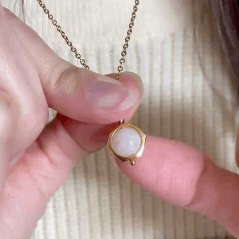 Animated spinning Luna moonstone fidget necklace, showcasing its movement for anxiety relief